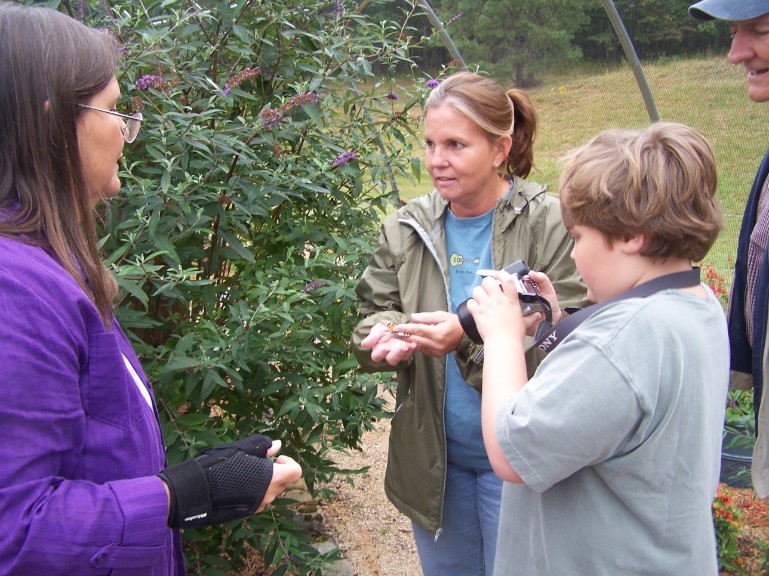 taking a picture while mom tags her butterfly